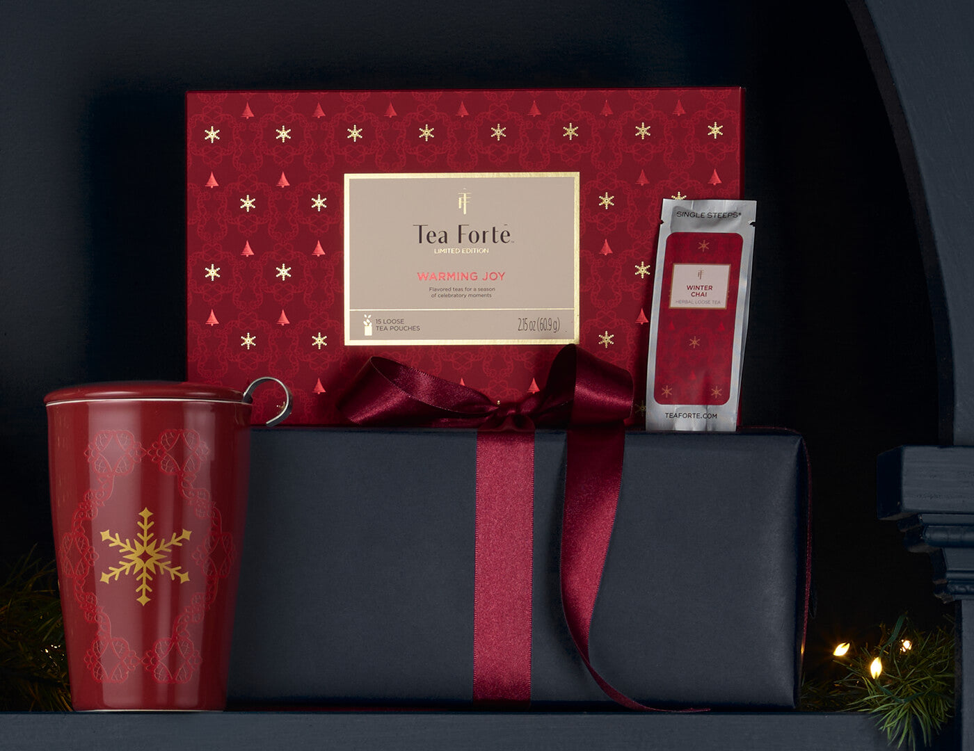 Single Steeps Sampler Warming Joy, closed with KATI Steeping Cup and loose tea pouch and wrapped presents