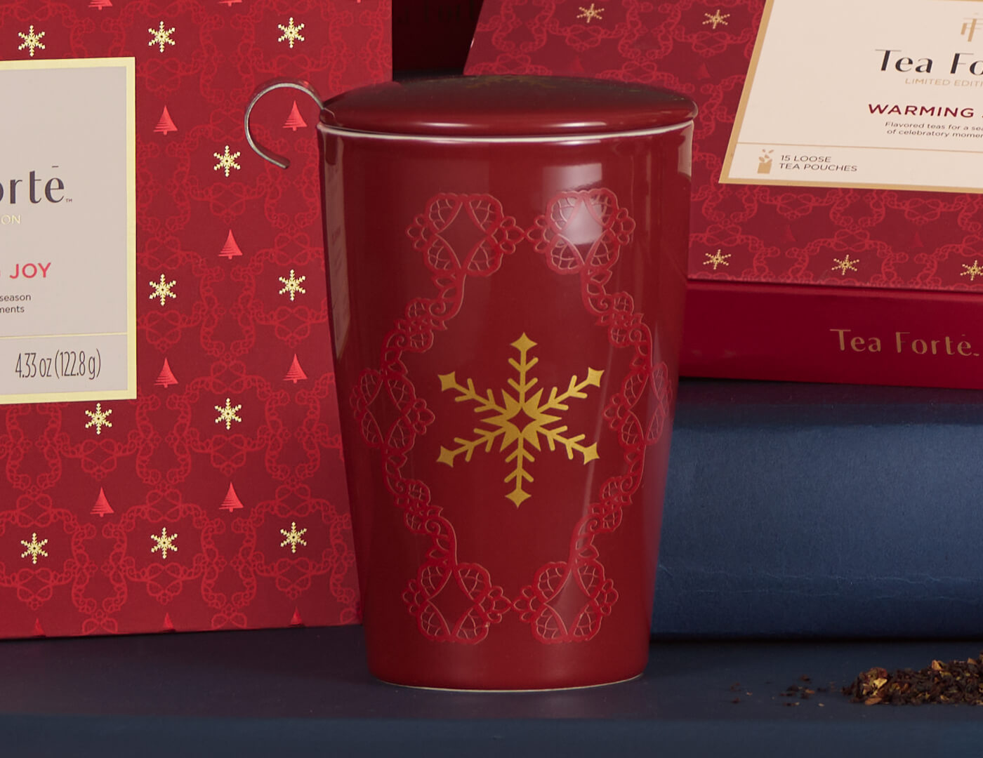 KATI® Steeping Cup & Infuser Warming Joy with other red boxes in background